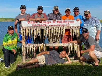 Group of men standing with their fishing catch
